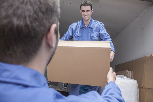 Removal team planning a house move in a Mill Hill residential street