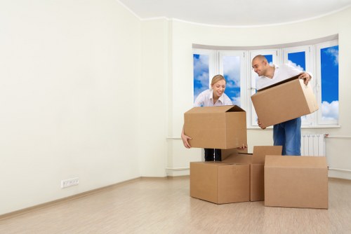 Movers carrying household boxes and furniture for a local relocation