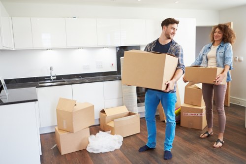 Professional movers handling furniture in a local Mill Hill move