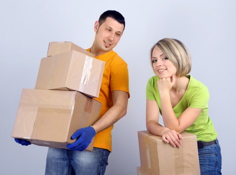 Packing supplies and protected furniture ready for a Mill Hill house move