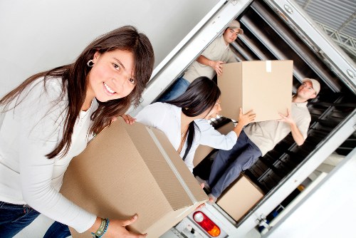 Local removals crew handling boxes and furniture with care