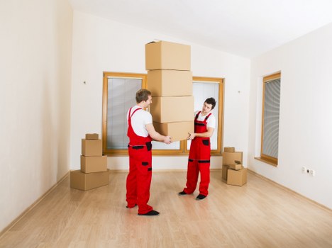 Office furniture being moved carefully through a building in Mill Hill
