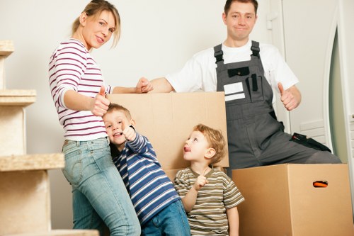 Moving crew transporting furniture from a Mill Hill property